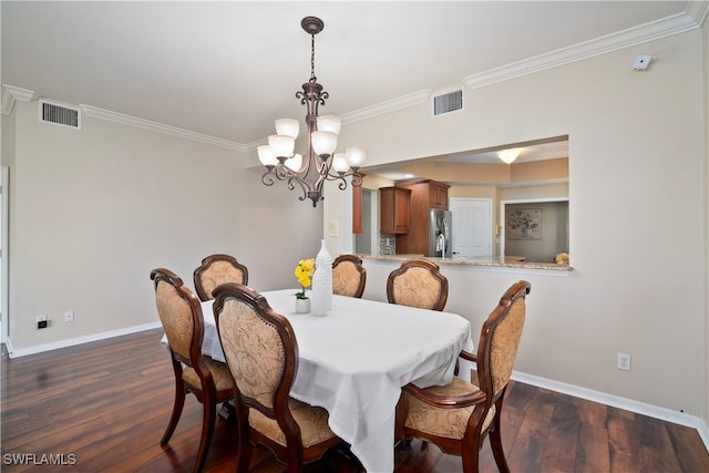 dining space featuring dark hardwood / wood-style flooring, crown molding, and an inviting chandelier