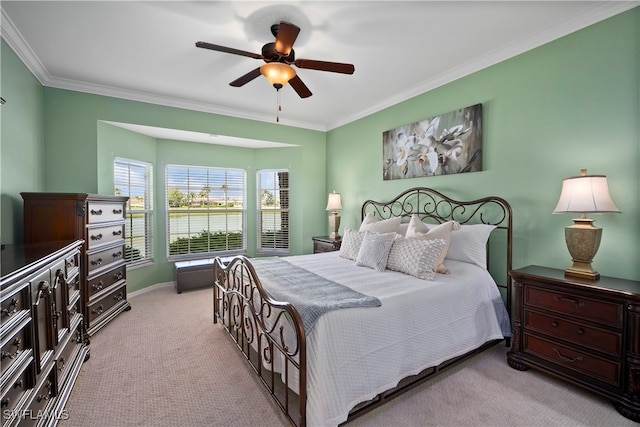 bedroom featuring light carpet, ceiling fan, and crown molding