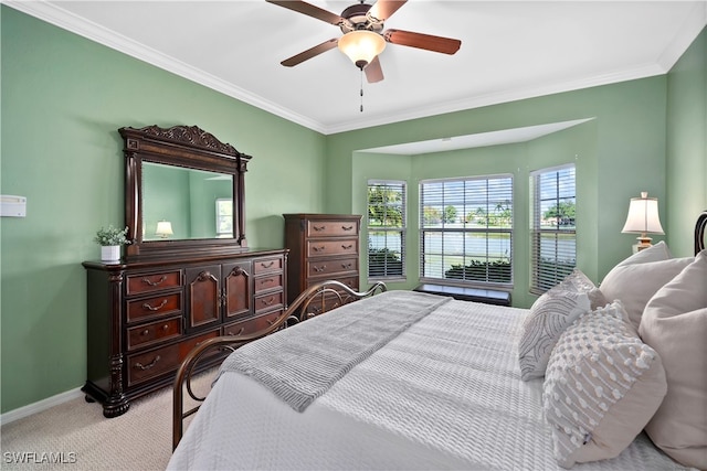 bedroom featuring ornamental molding, light colored carpet, and ceiling fan