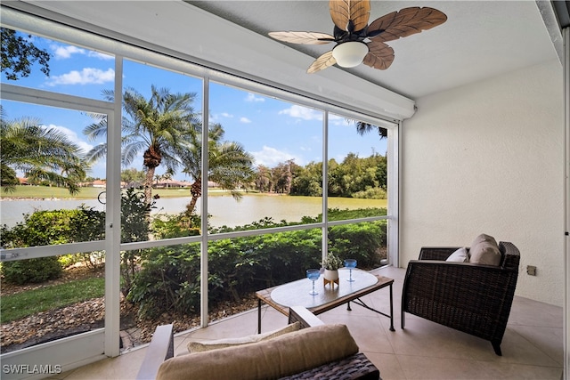 sunroom / solarium with a water view and ceiling fan