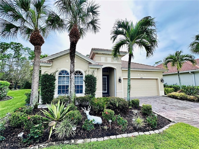 view of front of house featuring a garage and a front lawn