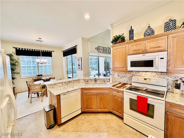 kitchen with decorative backsplash, a healthy amount of sunlight, white appliances, and ornamental molding