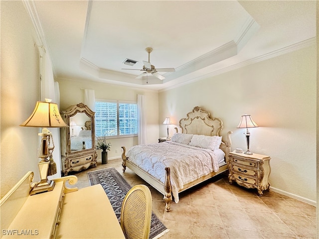 bedroom featuring ceiling fan, ornamental molding, light tile patterned floors, and a tray ceiling