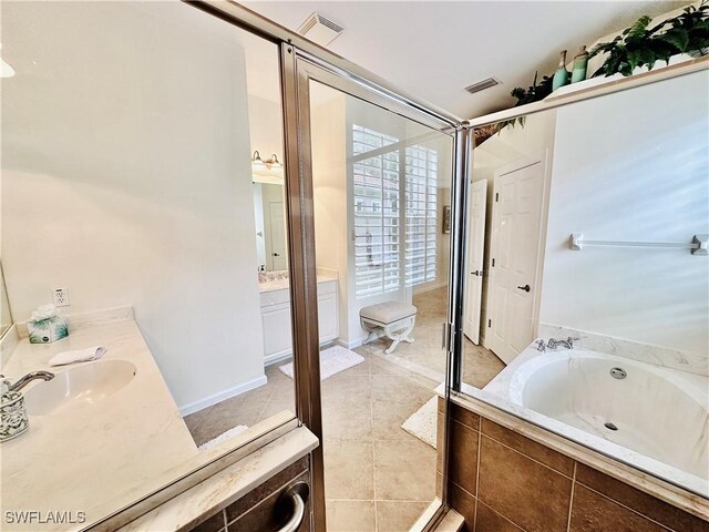 bathroom featuring tiled bath, tile patterned floors, and vanity