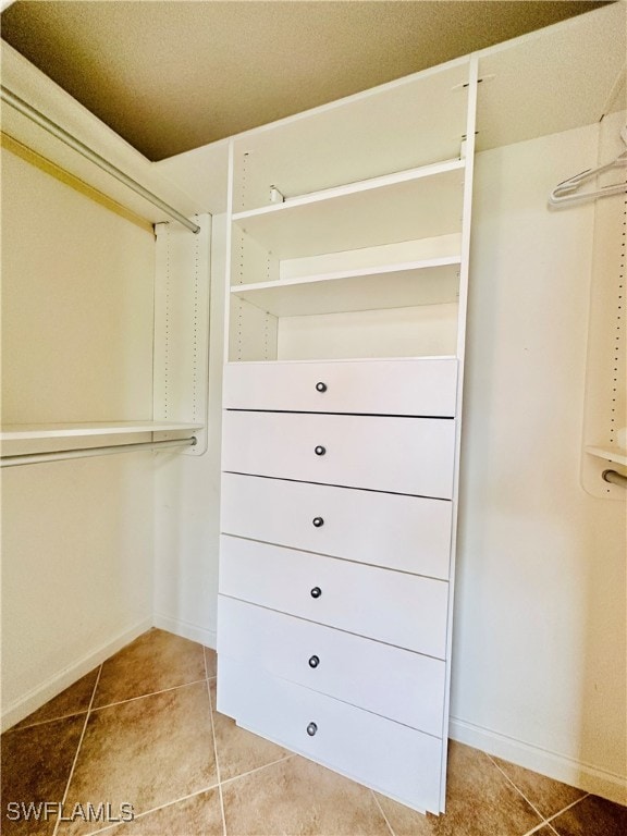 spacious closet featuring light tile patterned flooring