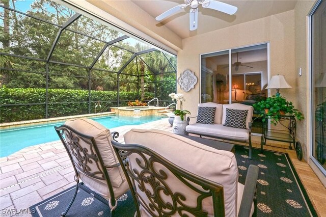 view of swimming pool featuring a patio, an in ground hot tub, ceiling fan, and glass enclosure