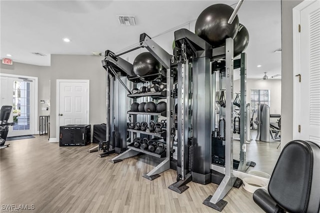 exercise room featuring french doors and light hardwood / wood-style floors