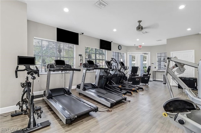 exercise room with a healthy amount of sunlight, french doors, ceiling fan, and light hardwood / wood-style floors