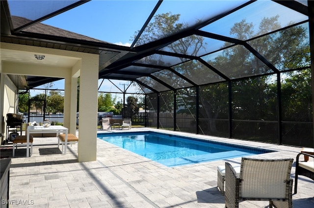 view of pool with a patio and a lanai