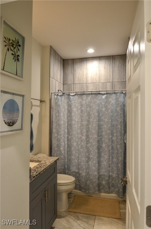 bathroom featuring vanity, toilet, and tile patterned floors