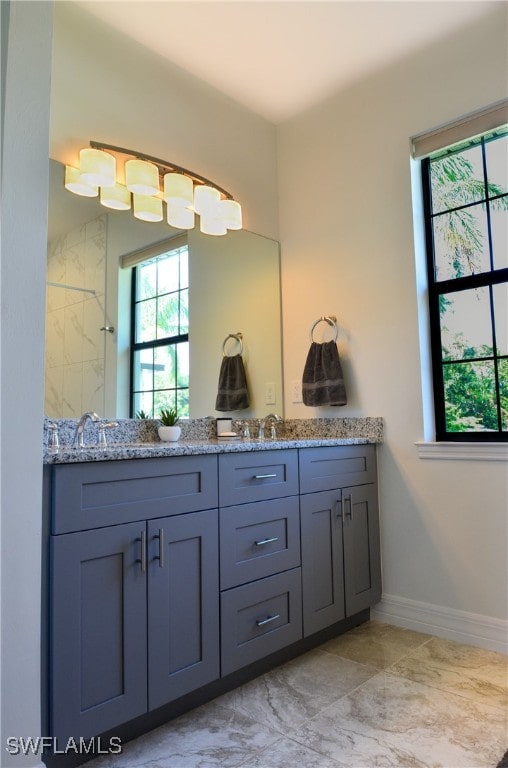 bathroom with tile patterned flooring and dual bowl vanity