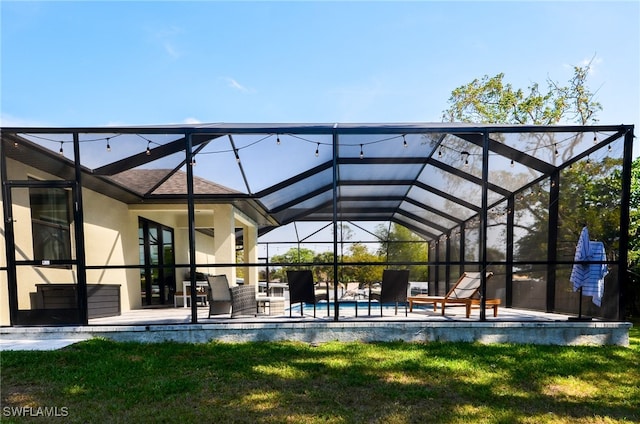 exterior space featuring a patio and glass enclosure