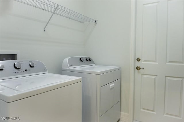 laundry room featuring separate washer and dryer