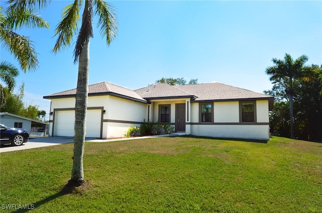 view of front facade with a garage and a front yard