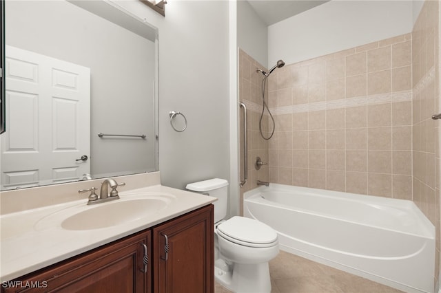 full bathroom featuring tile patterned flooring, toilet, vanity, and tiled shower / bath