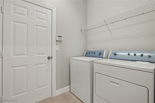 washroom featuring separate washer and dryer and light tile patterned floors