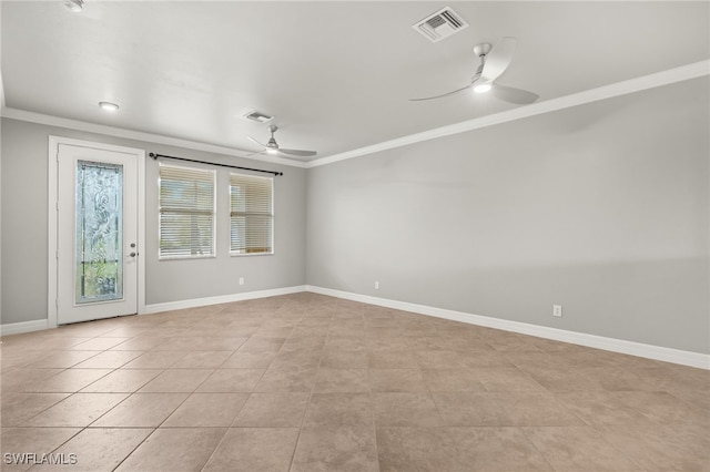 tiled empty room with ceiling fan and ornamental molding