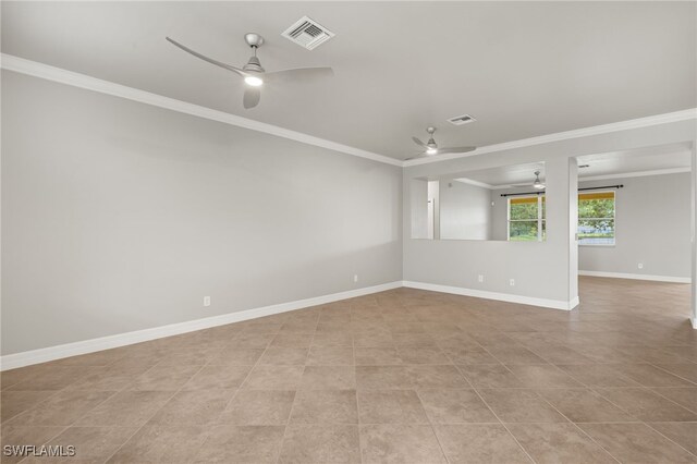 spare room featuring crown molding, light tile patterned floors, and ceiling fan