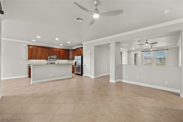 kitchen with light tile patterned flooring, crown molding, a kitchen island with sink, ceiling fan, and stainless steel appliances