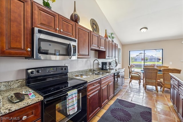 kitchen featuring sink, lofted ceiling, light stone countertops, and stove