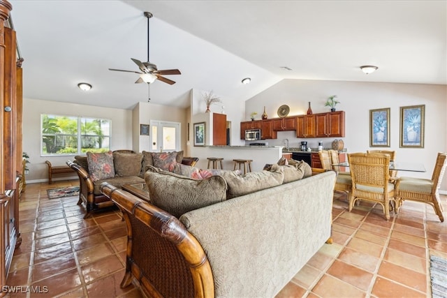 tiled living room with lofted ceiling, sink, and ceiling fan