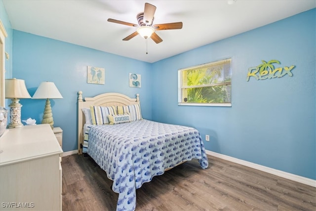 bedroom featuring ceiling fan and dark hardwood / wood-style floors