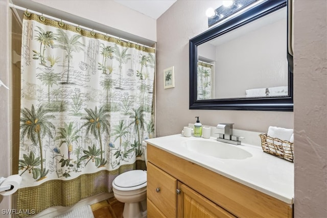 bathroom with tile patterned floors, vanity, and toilet