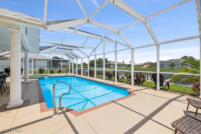 view of pool with a patio and glass enclosure