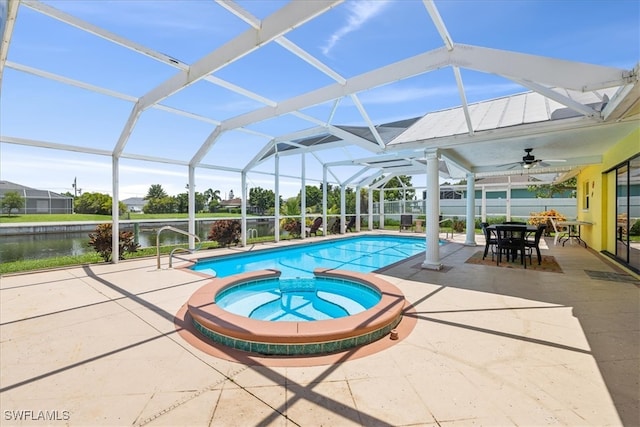 view of pool with a patio area, ceiling fan, an in ground hot tub, a water view, and a lanai