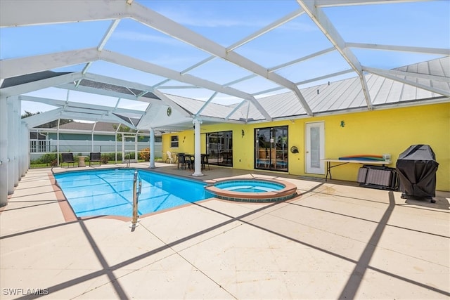 view of pool featuring a patio, an in ground hot tub, and a lanai