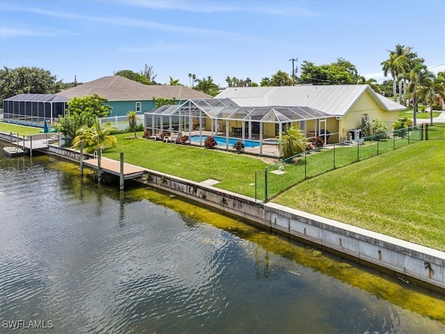 dock area with a lanai, a water view, a lawn, and a fenced in pool