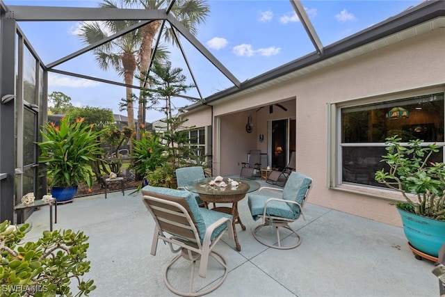 view of patio featuring a lanai