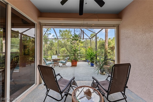 sunroom featuring ceiling fan and a wealth of natural light