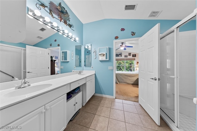 bathroom with a shower with shower door, double sink vanity, tile patterned flooring, ceiling fan, and vaulted ceiling