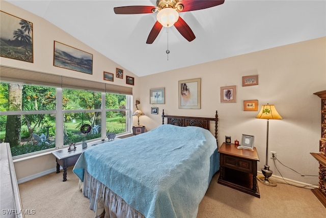 bedroom featuring ceiling fan, vaulted ceiling, and light colored carpet