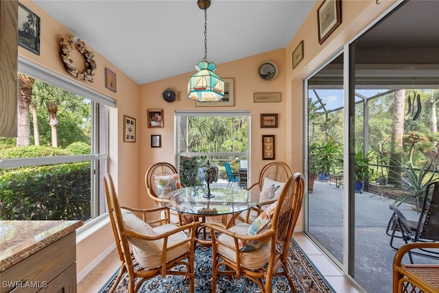 dining room with lofted ceiling, plenty of natural light, and light tile patterned floors