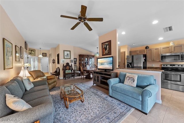 tiled living room with ceiling fan, vaulted ceiling, and a healthy amount of sunlight