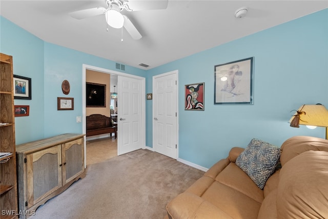 carpeted living room featuring ceiling fan