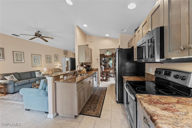 kitchen featuring light tile patterned flooring, stainless steel appliances, stone counters, ceiling fan, and kitchen peninsula