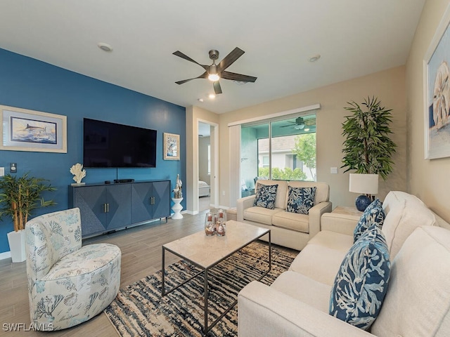 living room with hardwood / wood-style flooring and ceiling fan