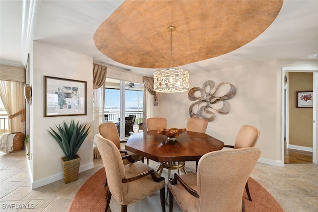 dining space with a raised ceiling