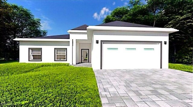 view of front of home featuring a front yard and a garage