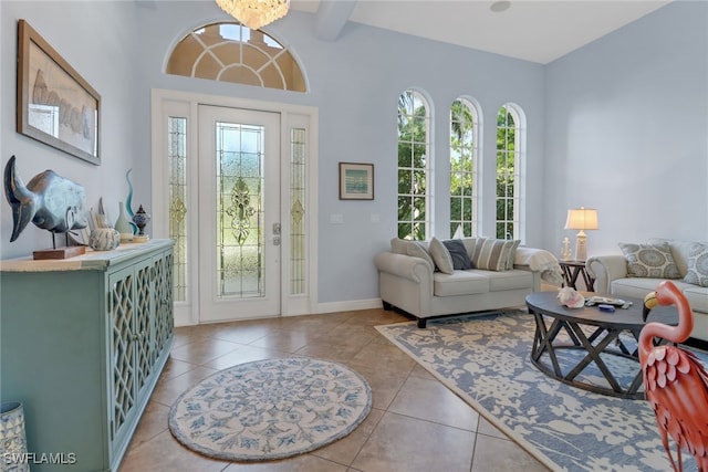 living room featuring beamed ceiling and light tile patterned floors