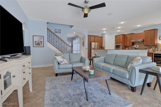 living room featuring ceiling fan, wine cooler, and light tile patterned floors