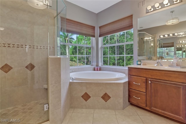 bathroom with tile patterned flooring, plus walk in shower, and vanity