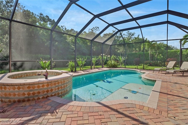 view of pool with a patio and glass enclosure