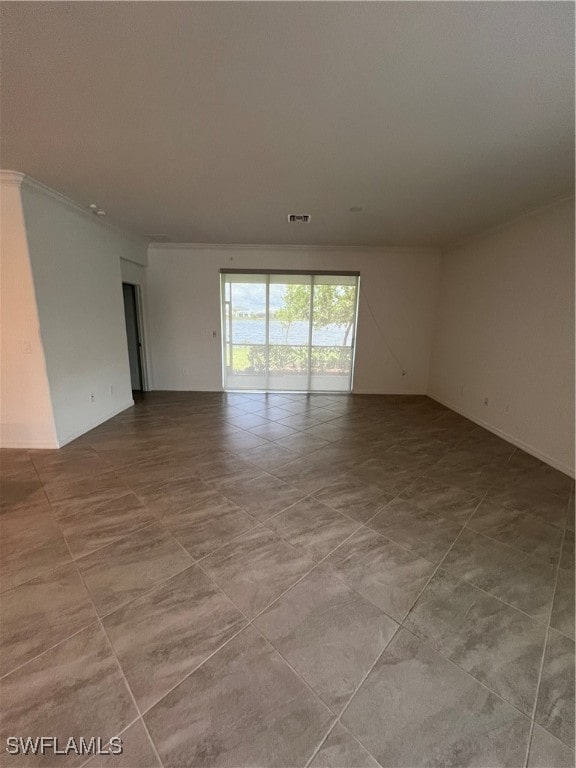 empty room featuring crown molding