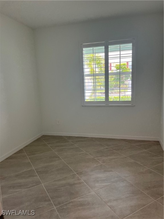 spare room with tile patterned floors