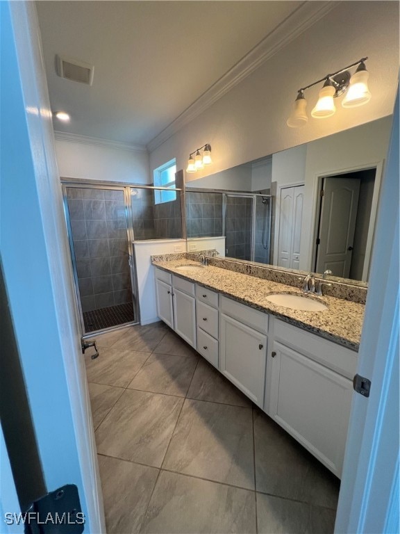 bathroom featuring walk in shower, vanity, tile patterned flooring, and crown molding