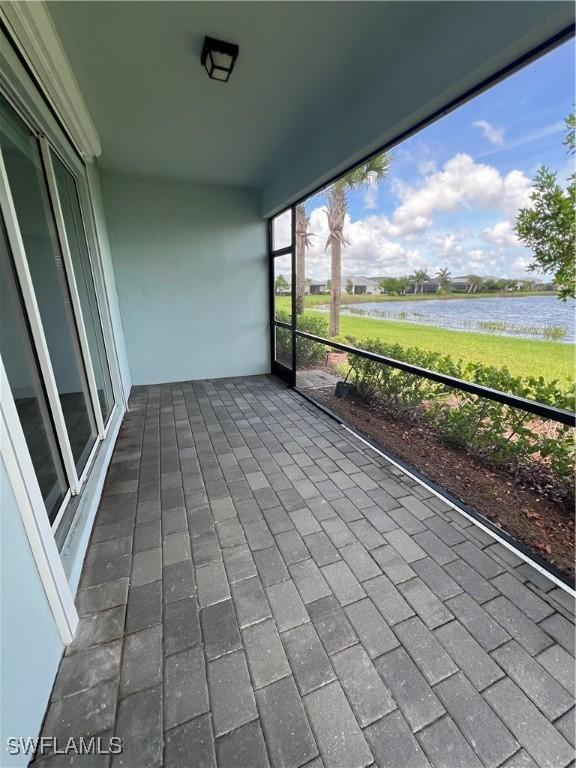 unfurnished sunroom with a water view